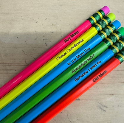 Colorful pencils on a wooden surface