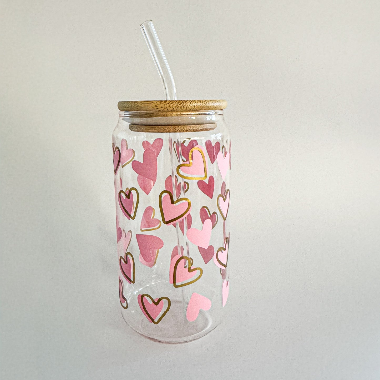 Pink and gold heart-patterned Valentine glass tumbler with bamboo lid and glass straw